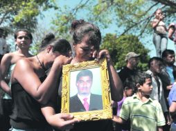 Familiares del reo fallecido Nery Ricardo Gómez Padilla, lloran en el Cementerio General de Comayagua, Honduras. AFP  /