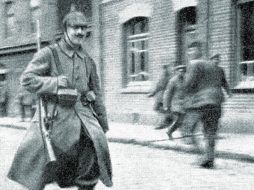 En la imagen, el soldado de primera, Adolf Hitler, cruza una calle adoquinada con fusil al hombro durante la I Guerra Mundial.ESPECIAL  /