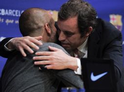 Guardiola y Rosell se dieron la mano y posteriormente se fundieron en un corto abrazo ante aplausos de los asistentes. AFP  /