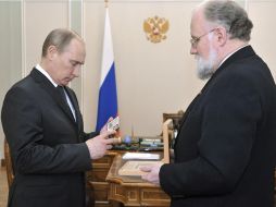 Vladímir Chúrov, entrega un certificado electoral al presidente ruso, Vladímir Putin (i). EFE  /