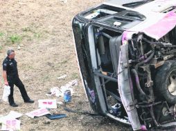 TRÁGICO. Un policía federal observa lo que quedó del camión. Las autoridades reportan que hay 22 personas heridas. EL UNIVERSAL  /