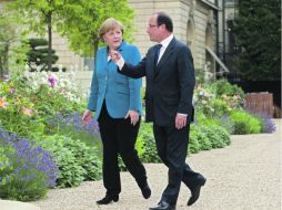 La canciller alemana y el presidente francés se reunieron el París para afinar posturas horas antes de la cumbre europea. AFP  /