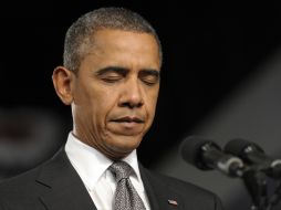 Obama cierra los ojos mientras ofrece un minuto de silencio por la víctimas del tiroteo. AP  /