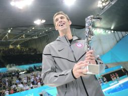 Pilón. Michael Phelps posa junto al trofeo que le otorgó la FINA, por sus logros conseguidos en tres ediciones de Juegos Olímpicos. AP  /