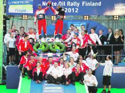 Sebastien Loeb y su copiloto, Daniel Elena, celebran junto a todo el equipo Citroën el triunfo obtenido en Finlandia. REUTERS  /