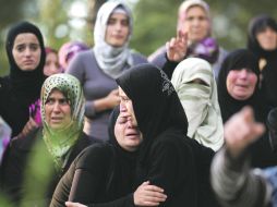 Mujeres sirias refugiadas rompen en llanto durante el funeral de cinco integrantes del rebelde Ejército Libre Sirio. REUTERS  /
