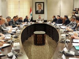 Se presume que el primer ministro sirio, Riad Hijab (c) ya tenía planeada su renuncia al Gobierno de Al Assad desde hace meses. AP  /