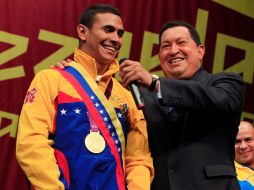 Junto al presidente Hugo Chávez, Limardo, vestido con el uniforme olímpico y su áurea presea. AP  /