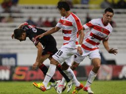 El jugador de Atlas Lucas Emanuel Ayala (C) disputa el balón con los jugadores de Jaguares George Ulises Corral (D). EFE  /