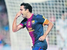 Xavi Hernández celebra su anotación, el tercer tanto del cuadro catalán, al minuto 78 del partido de ayer ante el Real Madrid. AP  /