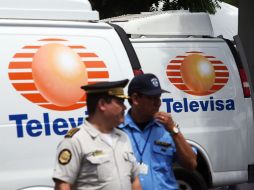 Miembros de la Policía vigilan los vehículos incautados a los falsos periodistas. EFE  /