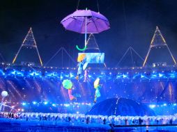 Bailarines bajan al Estadio Olímpico de Stratford en sombrillas durante la inauguración. AP  /