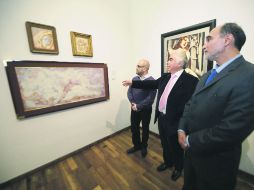 Igor Lozada, titular de Cultura UdeG (con lentes) y el escultor Víctor Manuel Contreras observan las obras de Tamara de Lempicka.  /
