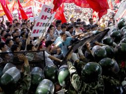 Miles de chinos asediaron el sábado la embajada japonesa en Beijing y arrojaron piedras, huevos y botellas. AP  /