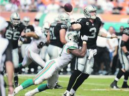 Carson Palmer, quarterback de los Raiders, es capturado por Cameron Wake, durante el juego en la casa de los Delfines. AP  /