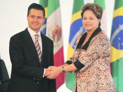 Lima asperezas. Enrique Peña Nieto y Dilma Rousseff hablaron del conflicto automotriz entre ambos países. AFP  /