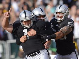 Janikowski (izq) levanta la mano luego de ganar el juego para los Raiders de Oakland. AP  /