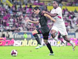 FRENO. Facundo Erpen, de Atlas, es detenidos por Luis Tejeda, del Toluca.  /