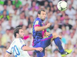 Amigos y rivales. Higuaín (Madrid) y Javier Mascherano (Barcelona), compañeros en la Albiceleste, se verán las caras hoy. GETTY IMAGES  /