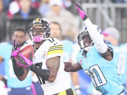 Cerca. Mike Wallace atrapa el ovoide, para un touchdown de 82 yardas. AP  /