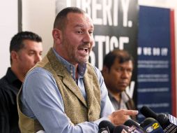 La demanda destaca el caso del cineasta británico e inmigrante legal Duncan Roy (c), quien pasó 89 días en prisión. AP  /