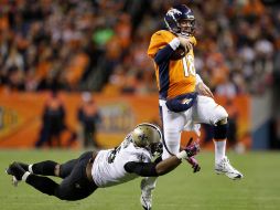 Tom Johnson se arroja sobre Peyton Manning durante el partido en Denver. AP  /