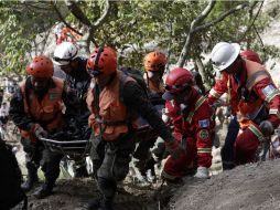 Bomberos colaboran con el rescate de cuerpos tras sismo. AFP  /