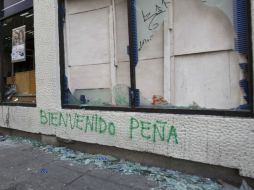 Manifestantes atacaron empresas y agentes de seguridad. XINHUA  /