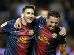 Lionel Messi (i) lidera la lista, mientras que su compañero Xavi (d) está ubicado en el tercer puesto. AP  /