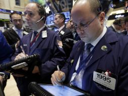 Su indicador más importante sumó 17.21 puntos hasta 13 mil 488.43. AP /