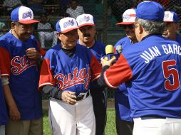 Juan García (centro) fue objeto de un homenaje durante el partido en la Liga Intersindical.  /
