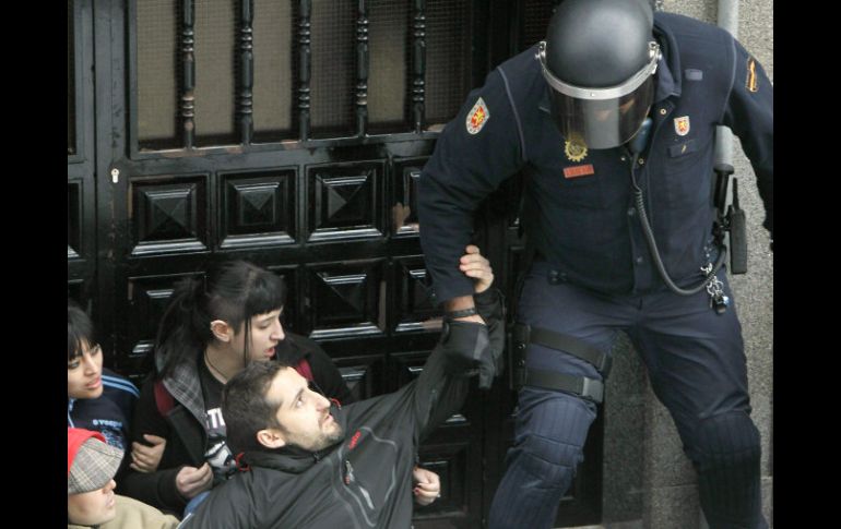 En España, un guardia civil procede a desahuciar a un obrero senegalés que no puede pagar la hipoteca de su piso. EFE /
