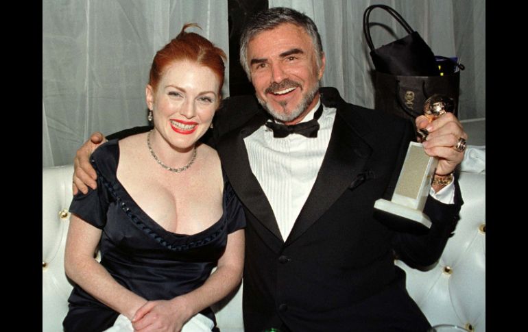 Reynolds sostiene su Globo de Oro, junto a Julianne More con quién compartió créditos en ''Boogey Nights'' ARCHIVO /