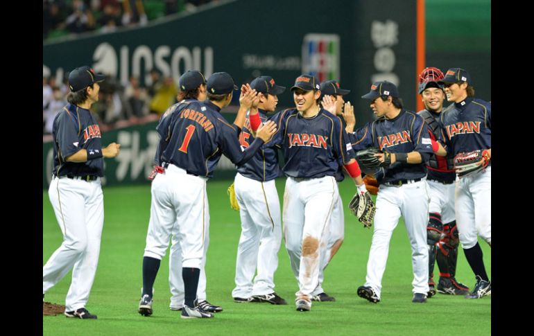 Los jugadores de Japón se felicitan luego de lograr su primer tirunfo en el Clásico Mundial de Beisbol. AFP /