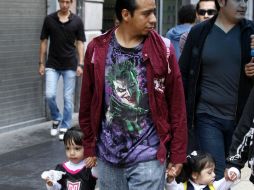 En la imagen, un padre de familia lleva de la mano a sus niñas. ARCHIVO /