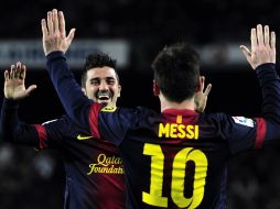 Villa y Messi celebran uno de los goles del Barcelona. AP /