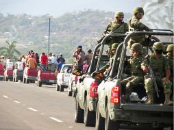 Elementos del Ejército custodian a residentes de Michoacán luego de los hechos violentos registrados el miércoles. EFE /