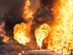 Las llamas alcanzaron seis tanques del depósito y parte de las instalaciones administrativas de la empresa. AFP /