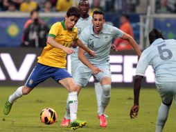 Oscar (izq) se prepara para sacar un disparo y anotar el primer gol del partido para los brasileños. EFE /