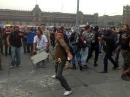 Jóvenes anarquistas se enfrentan a policías Granaderos en el Zócalo capitalino. SUN /