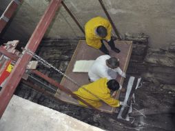 Miembros de las autoridades egipcias levantan piezas de madera de la segunda barca solar de Keops, de 4,500 años. EFE /