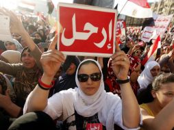 Egipcios detractores del presidente Mursi muestran pequeñas pancartas con la palabra ''Vete'' en árabe. EFE /