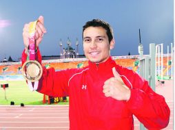 Luis Rivera sostiene la medalla de oro que logró tras superar al favorito y atleta local por más de cuatro centímetros. ESPECIAL /