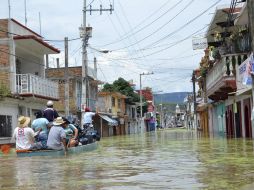 Por lo menos 120 viviendas se vieron afectadas por las inundaciones en Tixlta. AP /
