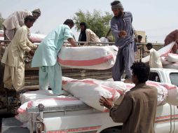 Voluntarios reparten las casas de campaña donde dorimirán quienes perdieron sus casas debido al sismo. EFE /