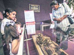 Cementerio de Altagracia. Visitantes observan uno de los cinco cuerpos momificados que fueron puestos en exhibición.  /