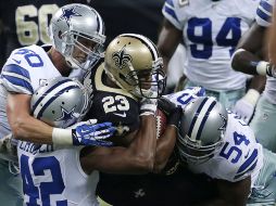 El corredor de los Santos de Nueva Orleans, Pierre Thomas (23) es derribado por la defensiva de los Vaqueros de Dallas. AP /