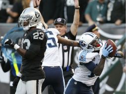 Kendall Wright (D) consiguió la anotación a diez segundos del final, a pase de Ryan Fitzpatrick. AP /