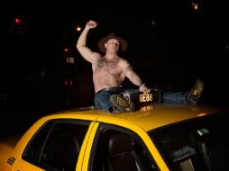 Una de las imágenes que integran el calendario sexy y cómico de taxistas de Nueva York. ESPECIAL /