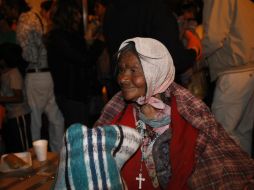 Una mujer sostiene una cobija que le regalaron.  /